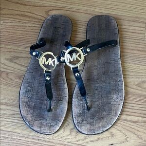 Michael Kors Black Thong Sandals with Gold MK Medallions